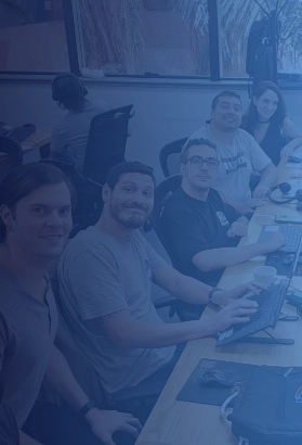 CIO Landing team in a collaborative workspace, working on laptops and IT solutions