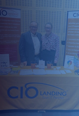 CIO Landing team members at an industry event booth, showcasing IT support services and cybersecurity solutions