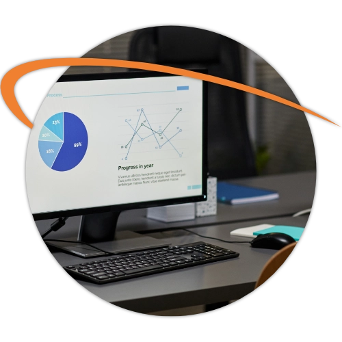Office desk with computer displaying financial charts and analytics
